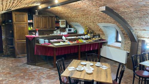 a restaurant with two tables and a counter with food at Pension Falko in Český Krumlov
