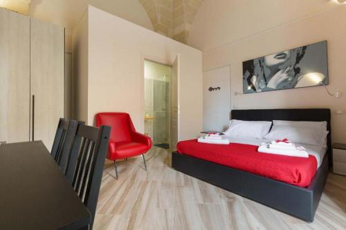 a bedroom with a red bed and a red chair at Salento Ada's House in Melendugno