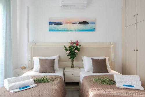 two beds in a room with a painting on the wall at Manuel's Dream in Ádhele