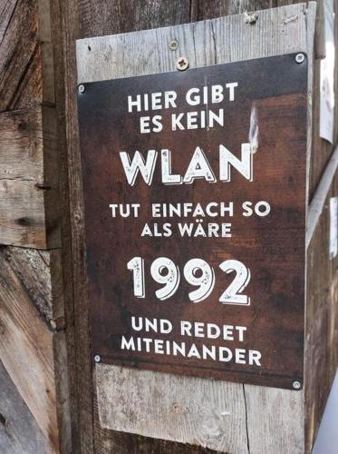a sign on the side of a wooden building at Gollitzalm in Harbach