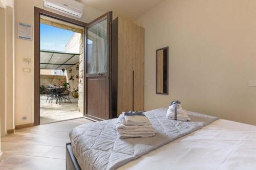 a bedroom with a bed with towels on it at Salento Ada's House in Melendugno