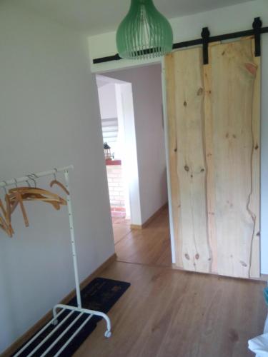 a room with a wooden door and a room with a treadmill at Bory Tucholskie Domek Starzyska in Osówek
