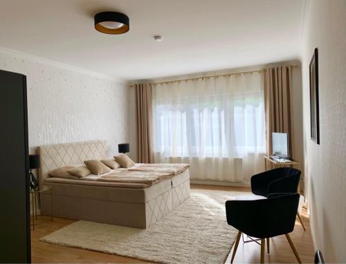 a bedroom with a bed and a large window at Pension Gerber in Erfurt