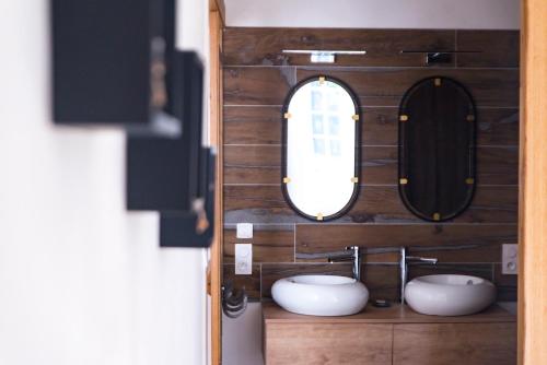 a bathroom with two sinks and a mirror at LE BAS CHITRAY in Ménil