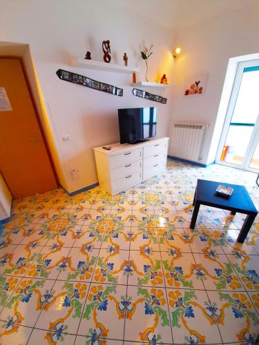 a living room with a tiled floor with a table at La Bomboniera in Maiori