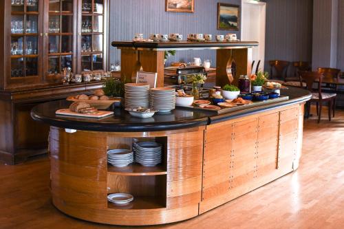 a buffet in a restaurant with plates and food at Rundhaug Gjestegard in Rundhaug