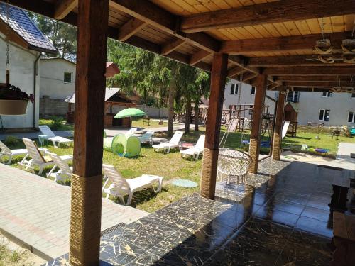 a pavilion with chairs and tables in a yard at Svitiaz Griada in Szack