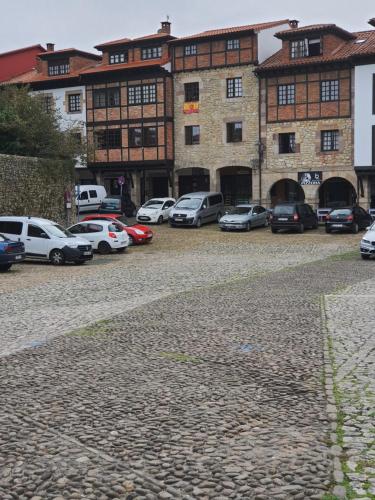 a group of cars parked in front of a building at El Arcángel de Santillana del Mar in Santillana del Mar