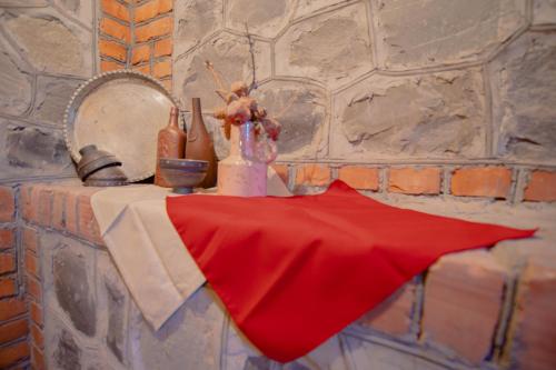 a table with a red napkin on top of it at Guest House "Old House" in Tʼelavi