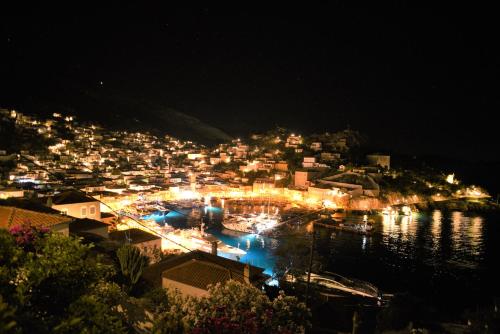 a view of a city at night with lights at Villa Sunset Hydra in Hydra