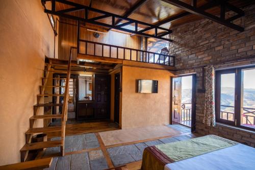 a room with a loft bed and a staircase in a building at BluSalzz Homes - The Himalayan Bungalow, Almora - Uttarakhand in Almora