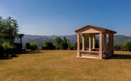 a gazebo in the middle of a field at BluSalzz Homes - The Himalayan Bungalow, Almora - Uttarakhand in Almora