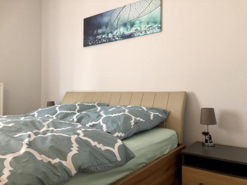 a bedroom with a bed with a picture on the wall at Ferienwohnung Mintbraun in Waldkirchen