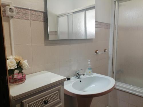 a bathroom with a sink and a mirror and a shower at Casa da Venda do Ferrador in Estremoz