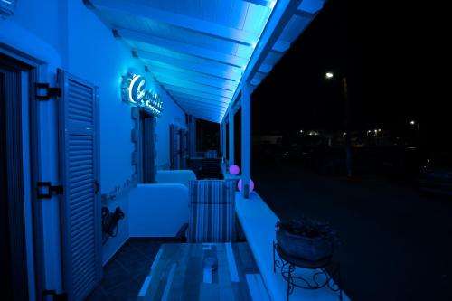 a building with blue lights on it at night at Coralli Rooms & Restaurant in Elafonisos