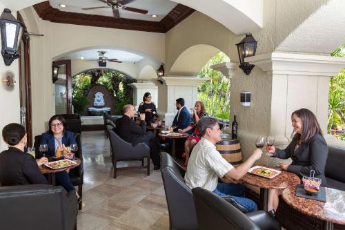 a group of people sitting at tables in a restaurant at Clarion Hotel Real Tegucigalpa in Tegucigalpa
