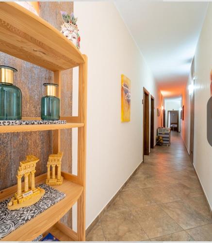 a hallway with wooden shelves in a room at Bed & breakfast Tre Palme in Raffadali