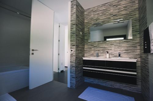 a bathroom with a sink and a mirror at Basto Village House - Eco Smart Luxury Villa in Cabeceiras de Basto