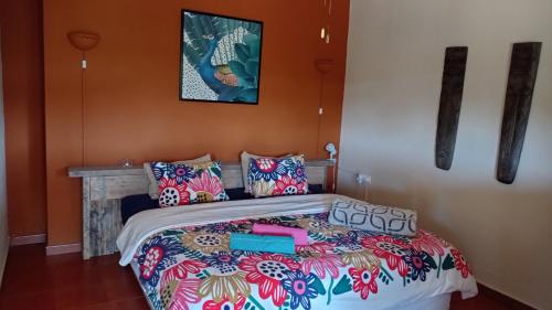 a bed room with a blue and white bedspread at Quinta Pereiro Tropic Garden, Algarve in Moncarapacho