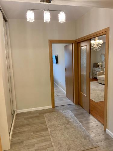 a room with a hallway with a door and a mirror at Central Luxury Apartment in Alba Iulia