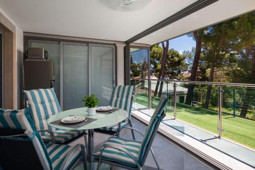 a dining room with a table and chairs on a balcony at VILLA AQUA - Adults Only in Bol