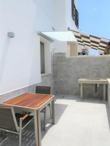 a dining room with a table and a bench at Appartamenti le Conchiglie 1 by Ferrocino Holiday in Lido Conchiglie