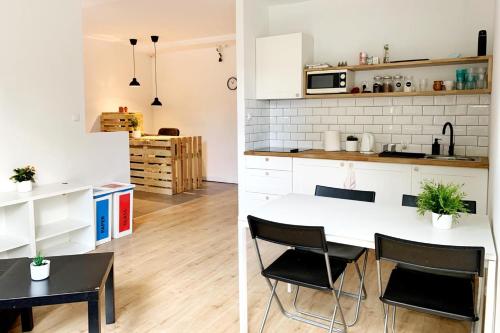 a kitchen and dining room with a table and chairs at Target Hostel in Zakopane