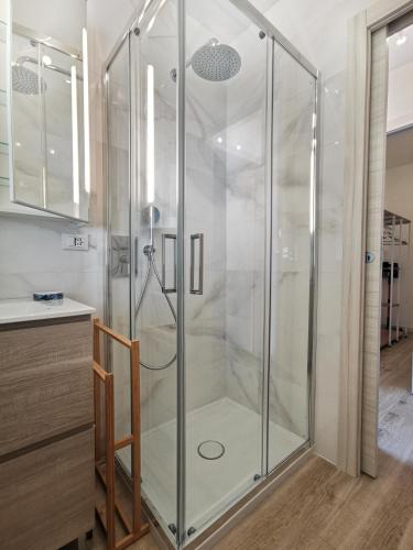 a shower with a glass door in a bathroom at Casa Pina in Tignale