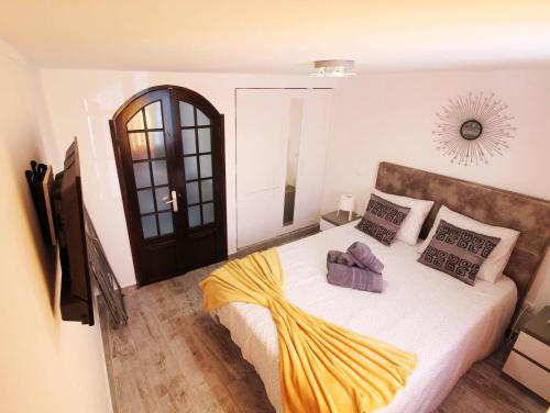 En eller flere senge i et værelse på Doce Lar Peniche