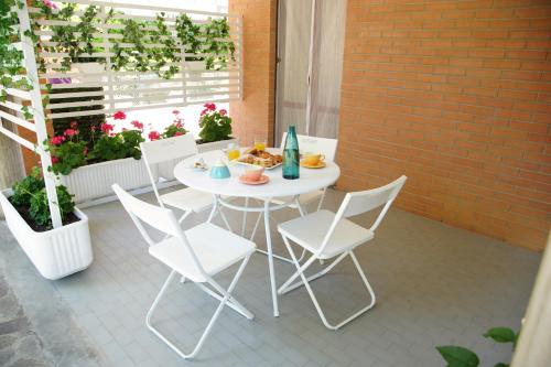 a white table and chairs on a patio at B&B Villino Giovanna Wi-Fi AC Prima fila mare Pineta in Porto SantʼElpidio