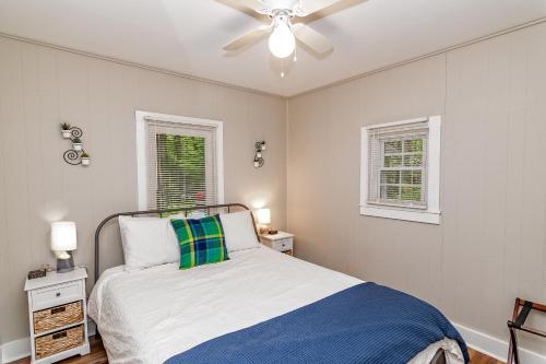 a bedroom with a bed and a ceiling fan at Camelback cottage - on ONE ACRE & near local attractions in Tannersville