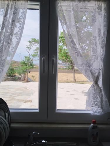 a window with a view of a street at Ακροδεα in Áno Gávrion