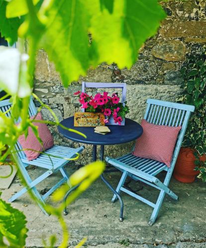 two chairs and a table with flowers on it at Holiday House Prodromos in Prodromos