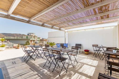 a patio with tables and chairs on a roof at Nonna Nina in Avola