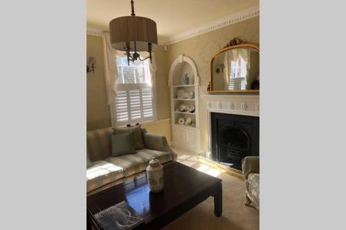 a living room with a couch and a fireplace at Luxury 2 bed Georgian Townhouse, Old Portsmouth in Portsmouth