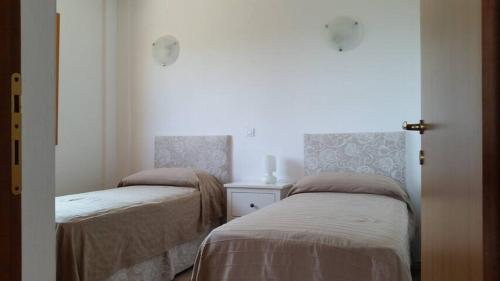 a bedroom with two beds and a window at Aliki House in Alyki