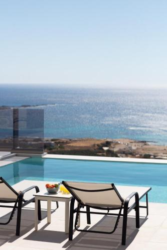 a patio with a table and chairs next to a pool at Falasarna village in Falasarna