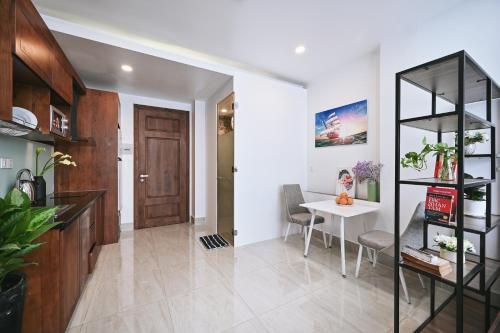 a living room with a table and a door at Qhome in Ho Chi Minh City