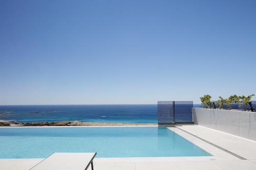 a swimming pool with a view of the ocean at Falasarna village in Falasarna