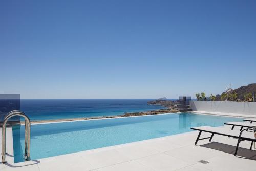 a swimming pool with a view of the ocean at Falasarna village in Falasarna