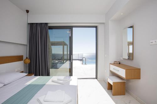 a bedroom with a bed and a view of the ocean at Falasarna village in Falasarna