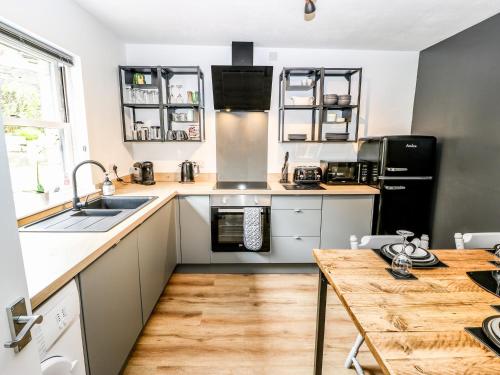 a kitchen with a sink and a counter top at Victoria House in Holmfirth