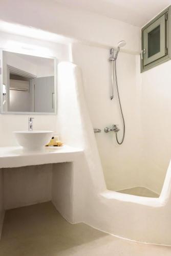 a white bathroom with a sink and a shower at Hotel Senia - Onar Hotels Collection in Naousa