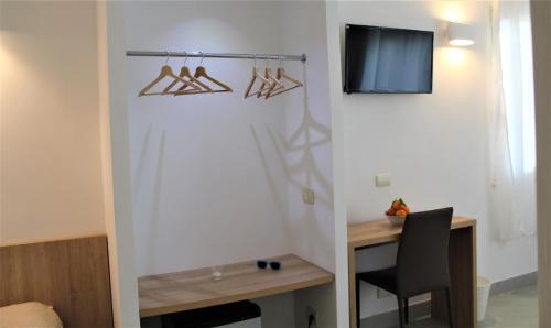 a room with a desk and a chair and a tv at Hotel - Giardino Marchese D'Altavilla in Tropea
