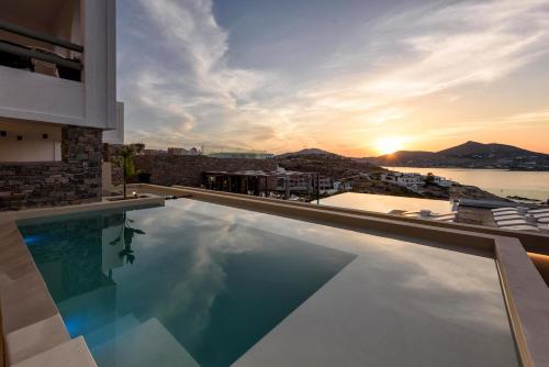 a swimming pool on a building with a view of the ocean at Hotel Senia - Onar Hotels Collection in Naousa