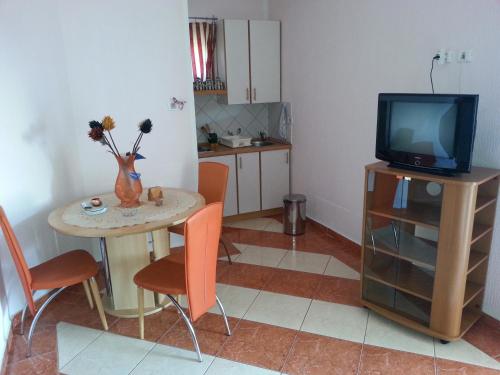 a living room with a small table and a television at Apartments Stevo Nikočević in Bar