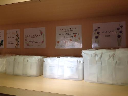 a shelf with white bags on it with writing on the wall at Matsumoto Tourist Hotel in Matsumoto