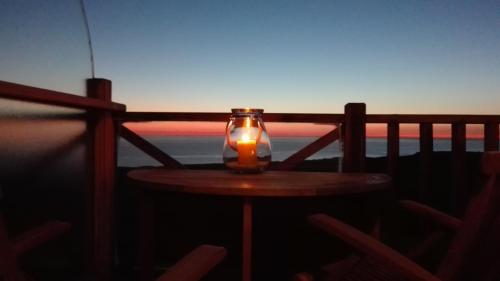 a candle sitting on top of a table on a balcony at La Naturelle Duplex 90 in Wimereux