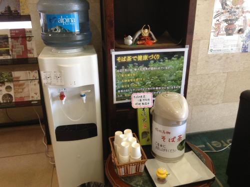 a drink dispenser next to a coffee machine in a store at Matsumoto Tourist Hotel in Matsumoto