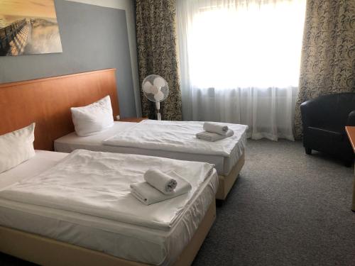 Postel nebo postele na pokoji v ubytování Hotel Royal Hanau